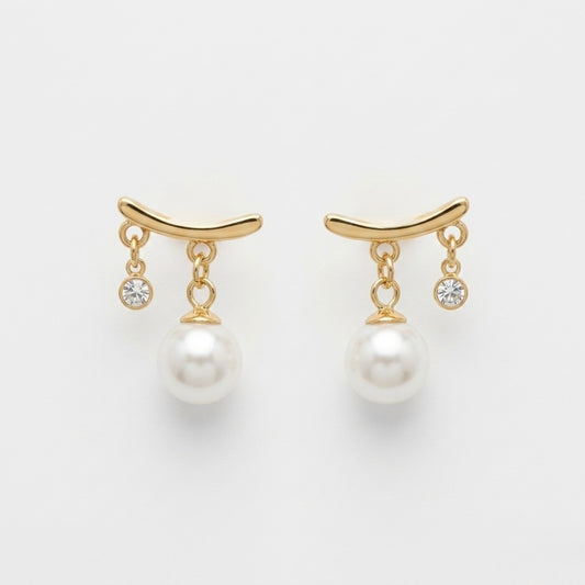 A pair of gold-plated arc drop earrings for women featuring a central white pearl and a small clear crystal, shown on a white background.