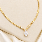 A gold-plated stainless steel chain for women featuring a V-shaped mounting and a large sparkling teardrop crystal pendant