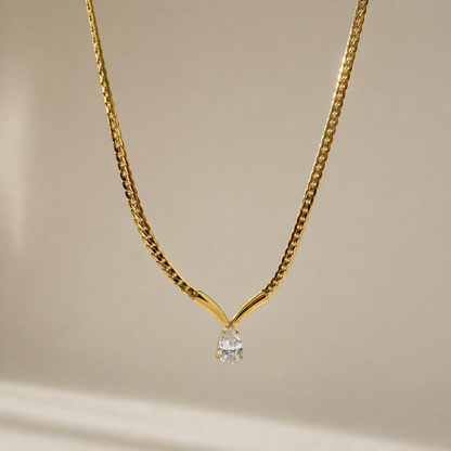 A gold-plated stainless steel chain for women featuring a V-shaped mounting and a large sparkling teardrop crystal pendant
