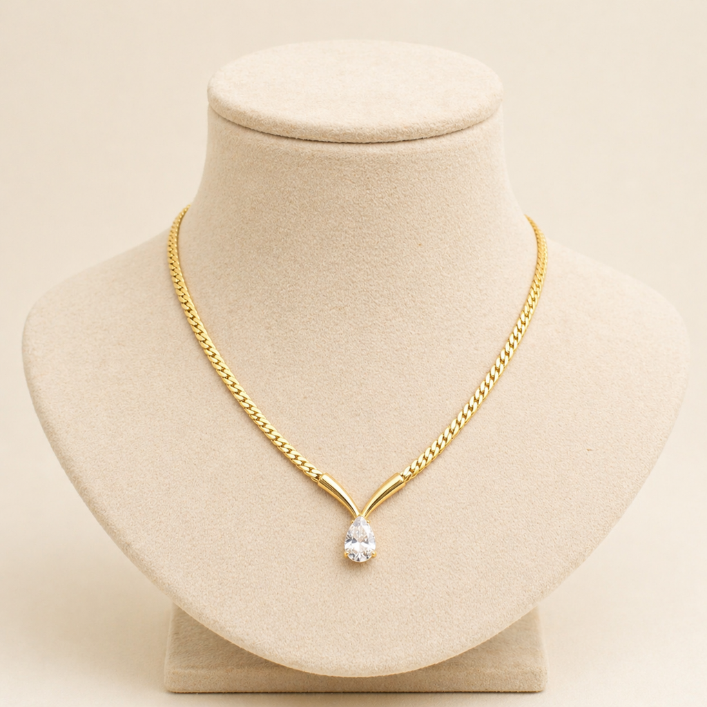 A gold-plated stainless steel chain for women featuring a V-shaped mounting and a large sparkling teardrop crystal pendant