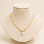 A gold-plated stainless steel chain for women featuring a V-shaped mounting and a large sparkling teardrop crystal pendant