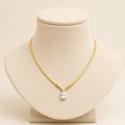 A gold-plated stainless steel chain for women featuring a V-shaped mounting and a large sparkling teardrop crystal pendant
