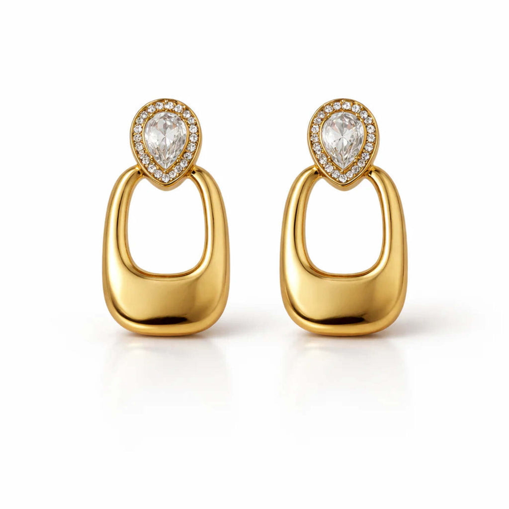 A pair of gold-plated long earrings for women featuring a pear-cut crystal halo stud and a large, smooth rectangular golden drop.