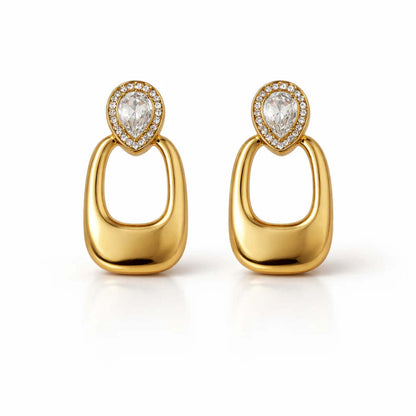 A pair of gold-plated long earrings for women featuring a pear-cut crystal halo stud and a large, smooth rectangular golden drop.