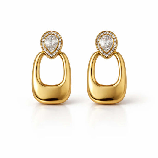 A pair of gold-plated long earrings for women featuring a pear-cut crystal halo stud and a large, smooth rectangular golden drop.