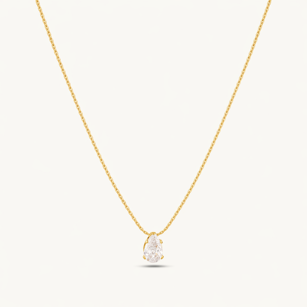 A gold-plated stainless steel chain for women featuring a single, brilliant pear-cut crystal pendant on a delicate link chain.