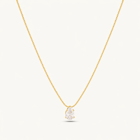 A gold-plated stainless steel chain for women featuring a single, brilliant pear-cut crystal pendant on a delicate link chain.