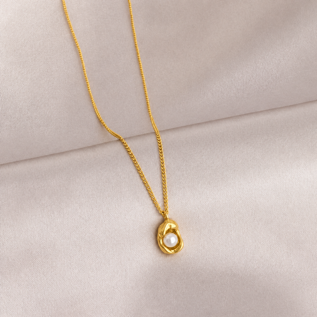 A gold-plated stainless steel chain for women featuring an organic, molten-gold pendant set with a single white pearl
