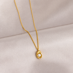 A gold-plated stainless steel chain for women featuring an organic, molten-gold pendant set with a single white pearl