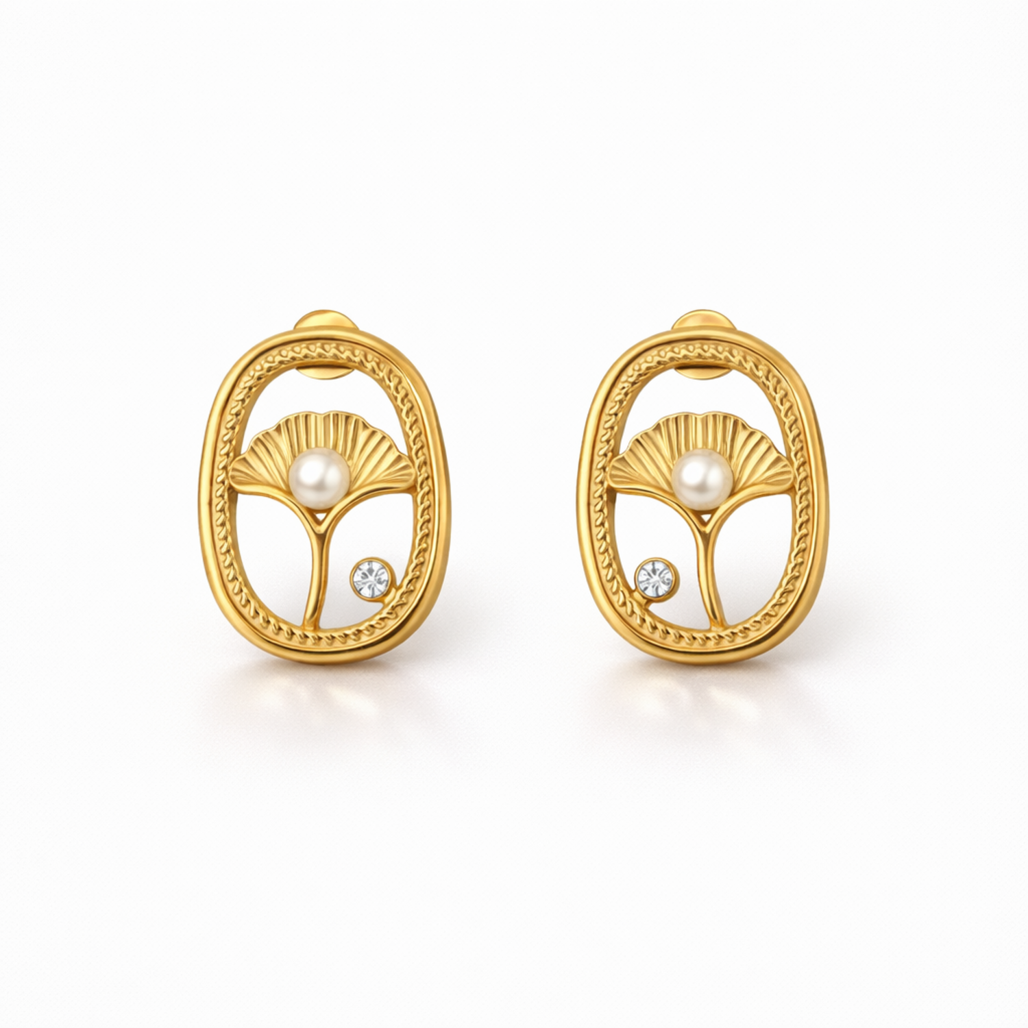 A pair of gold-plated oval stud earrings for women featuring an shell design with a central pearl and a small crystal, shown on a white background.