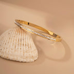 A gold-plated bracelet for women featuring a row of channel-set square-cut crystals and a secure side-clasp.