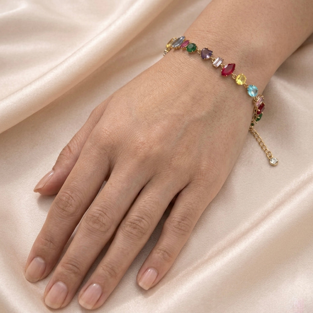 A gold-plated multi-color chain bracelet for women featuring various stone shapes on a model hand
