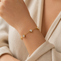 A gold-plated ladies bracelet featuring a fine chain and five strategically spaced square-cut princess crystals in bezel settings, shown on a model
