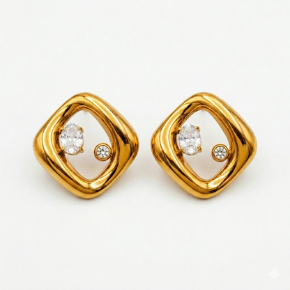 A pair of gold-plated abstract rhombus-shaped stud earrings for women featuring two floating crystals inside a molten gold frame, shown on a white background.
