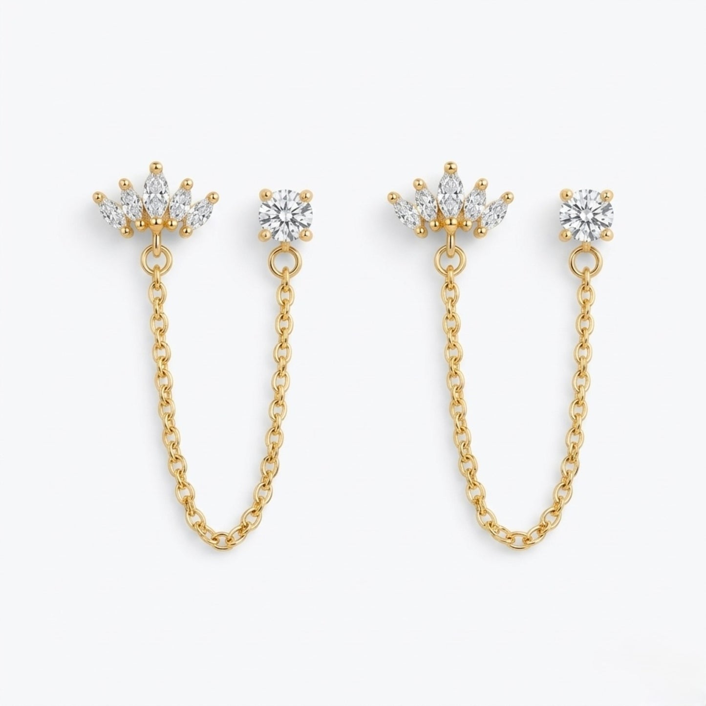 A pair of premium gold-plated ear chain earrings for women featuring a five-stone marquise crown stud and a round white stone stud connected by a delicate gold chain on a white background