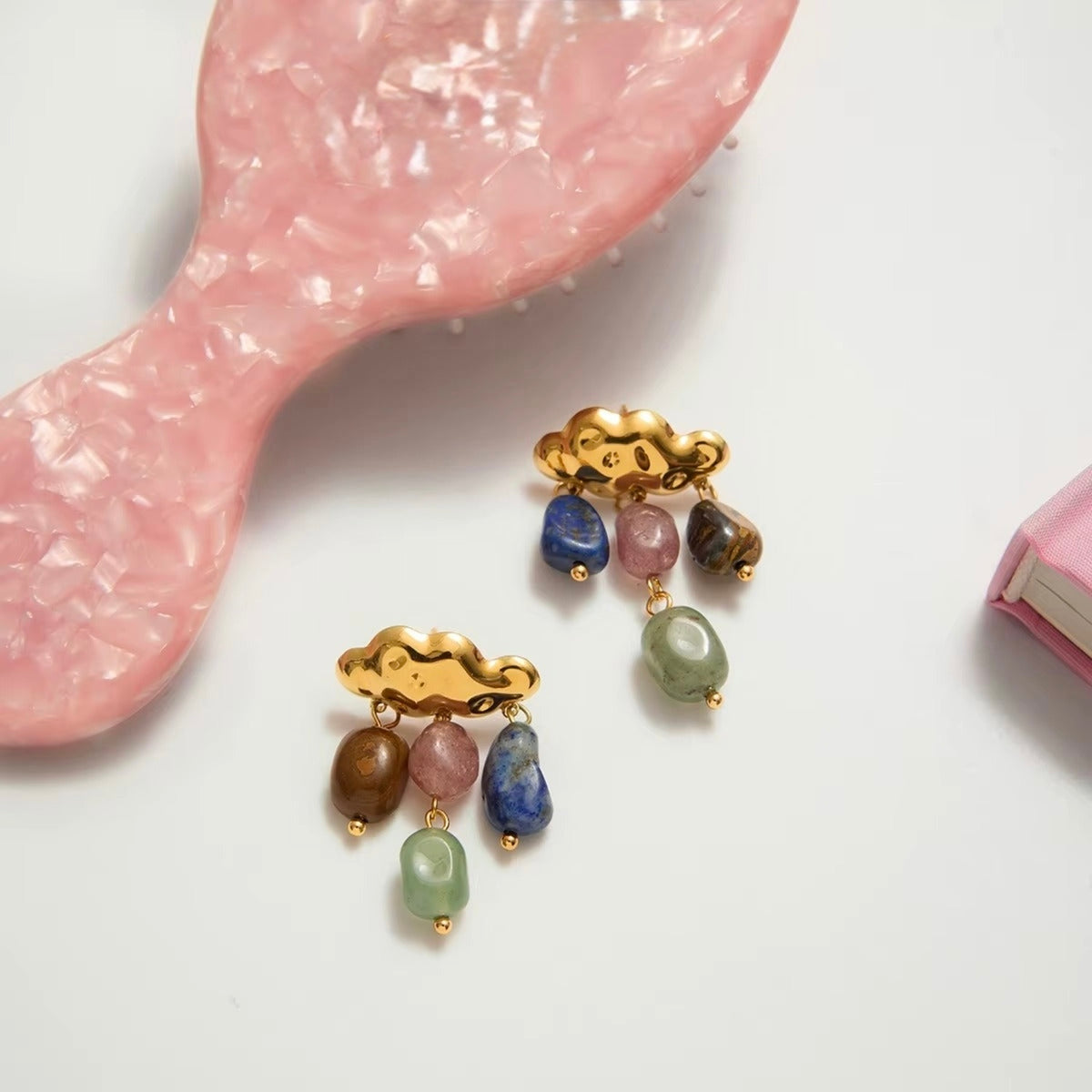 Raincloud Gemstone Drop Earrings with colourful gemstone drops and cloud-inspired gold plated earrings on white background