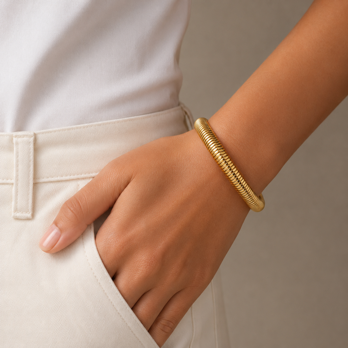 18K gold plated ribbed snake chain bangle for women with a sleek polished finish and anti-tarnish design on a model hand