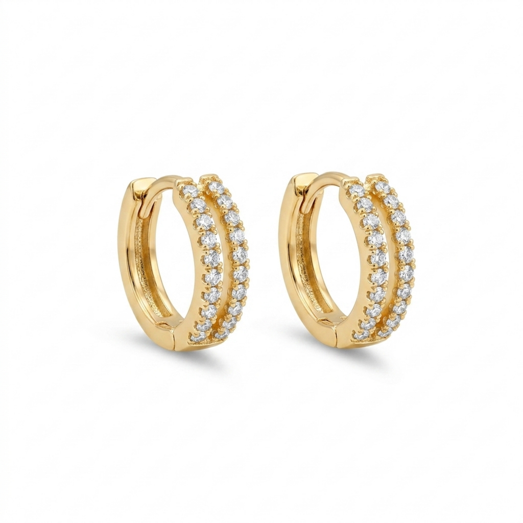 A pair of gold-plated huggie hoop earrings for women featuring two parallel rows of clear crystals, shown on a clean white background.