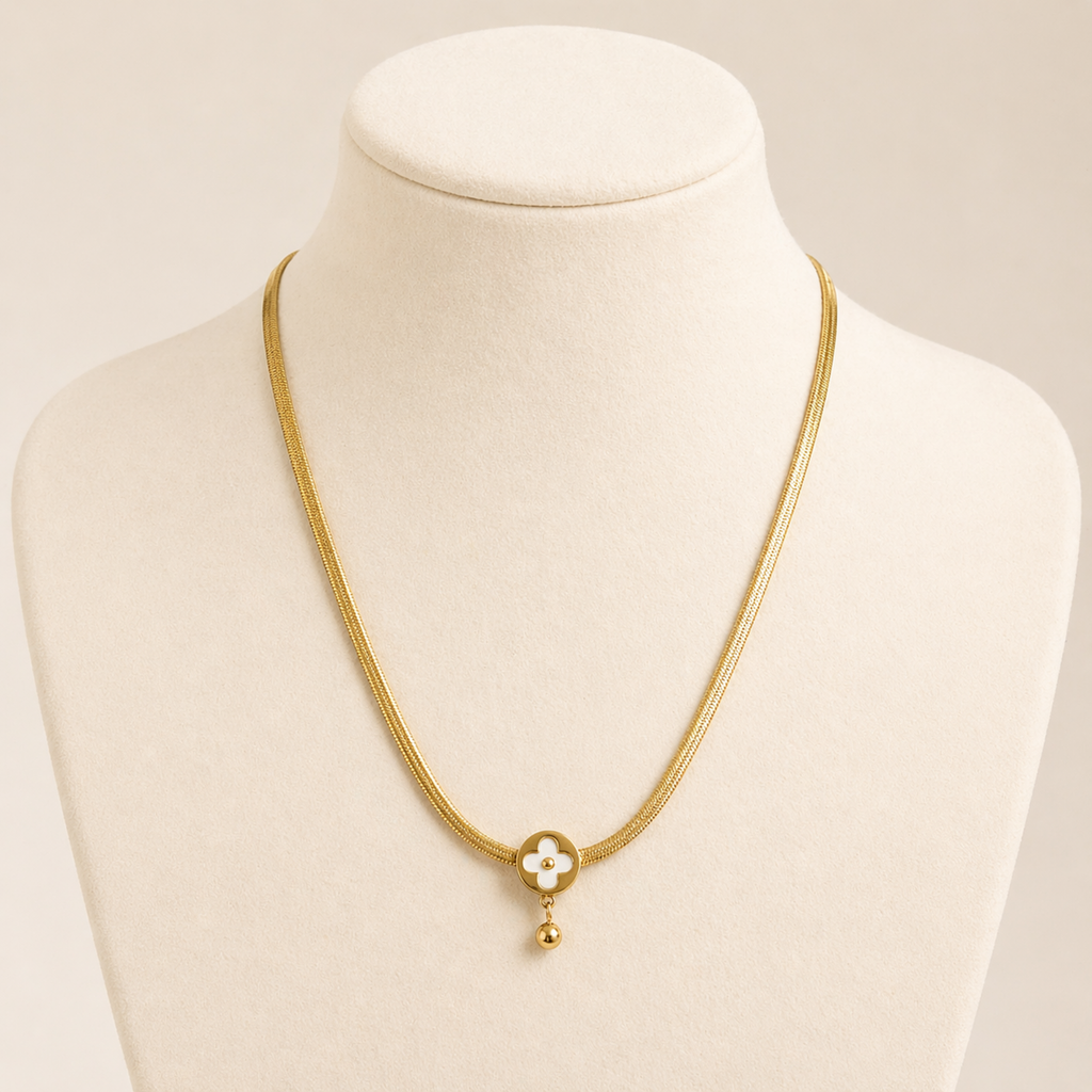 A gold-plated stainless steel chain for women featuring a flat high-shine texture and an open clover pendant with a small gold drop shown on display