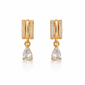A pair of gold-plated huggie hoop earrings for women featuring a suspended clear pear-shaped crystal drop, shown on a clean white background.