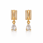 A pair of gold-plated huggie hoop earrings for women featuring a suspended clear pear-shaped crystal drop, shown on a clean white background.