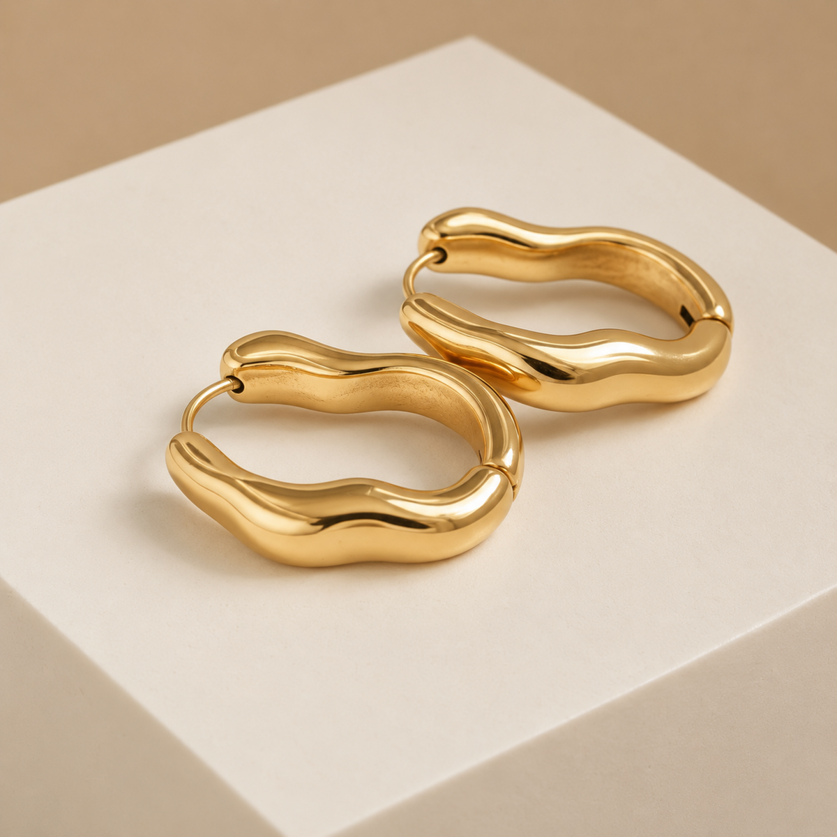 Sienna wavy hoop earrings for women with an organic curved design, 18K gold plated finish and anti-tarnish coating