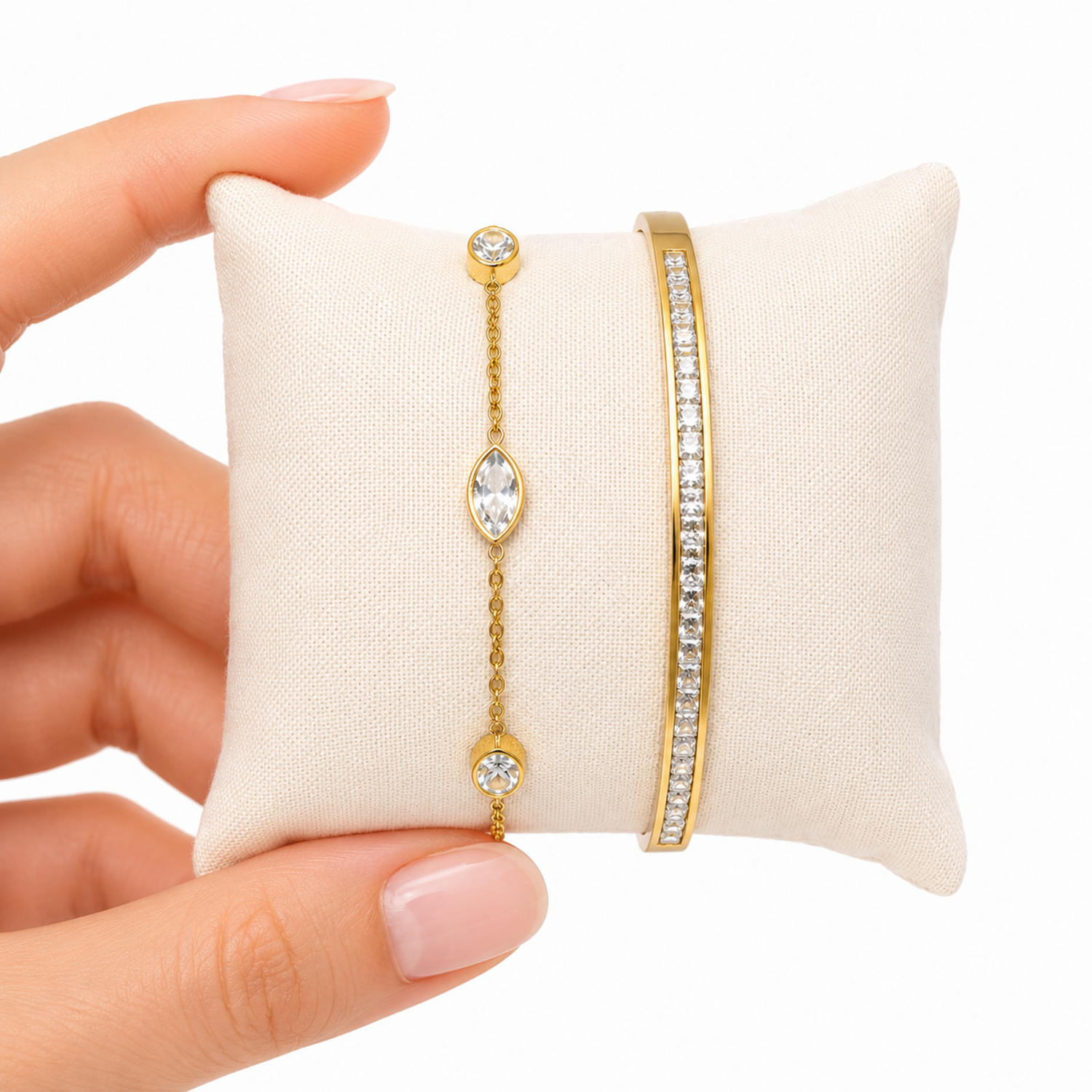 A two-piece gold-plated bracelet stack for women featuring a bangle and a delicate bezel-set crystal chain bracelet