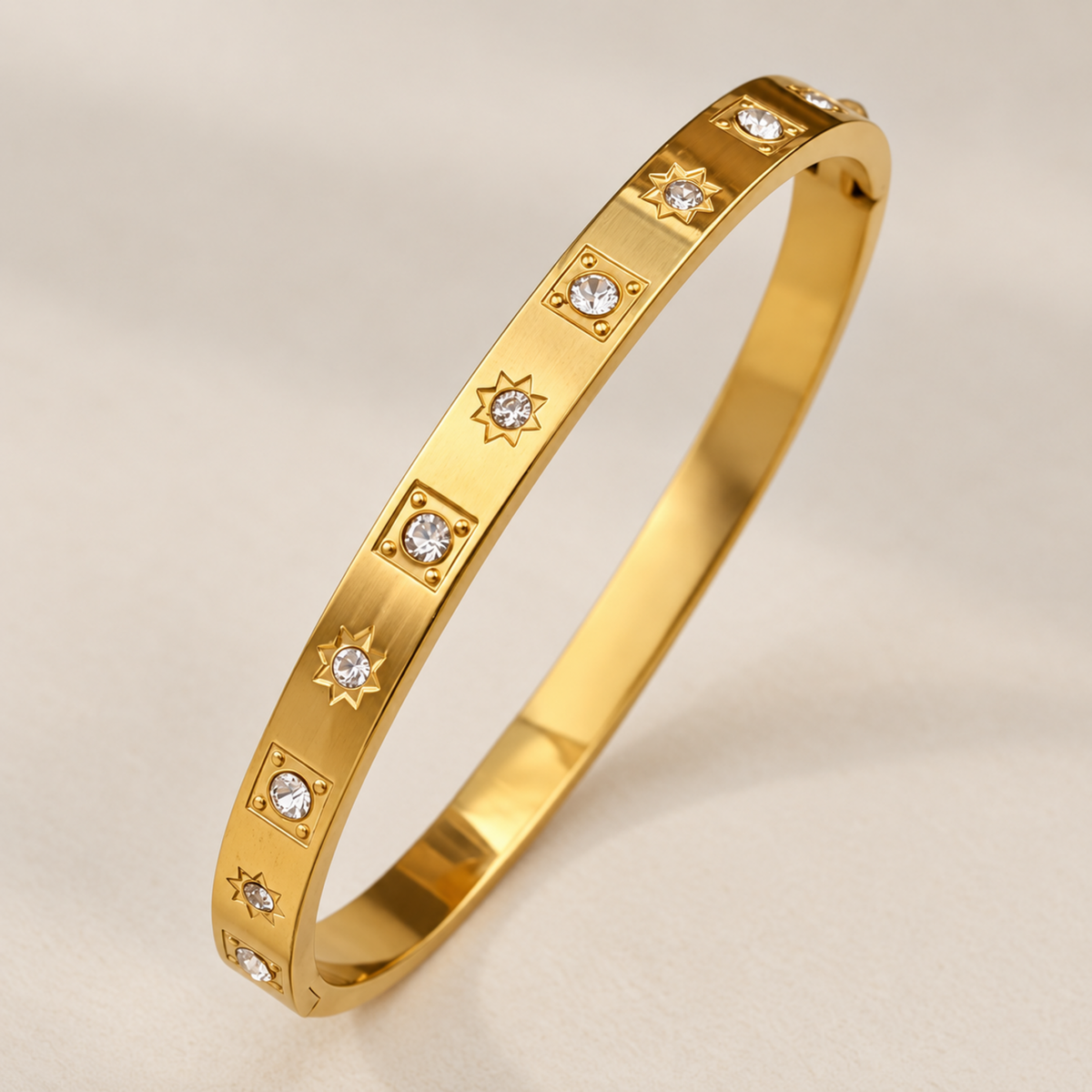 Gold crystal bangle for women with starburst and geometric crystal details and 18kt gold plated finish