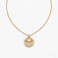 A gold-plated stainless steel necklace for women featuring a circular sunburst pendant with three small crystals at the bottom, shown against a white background