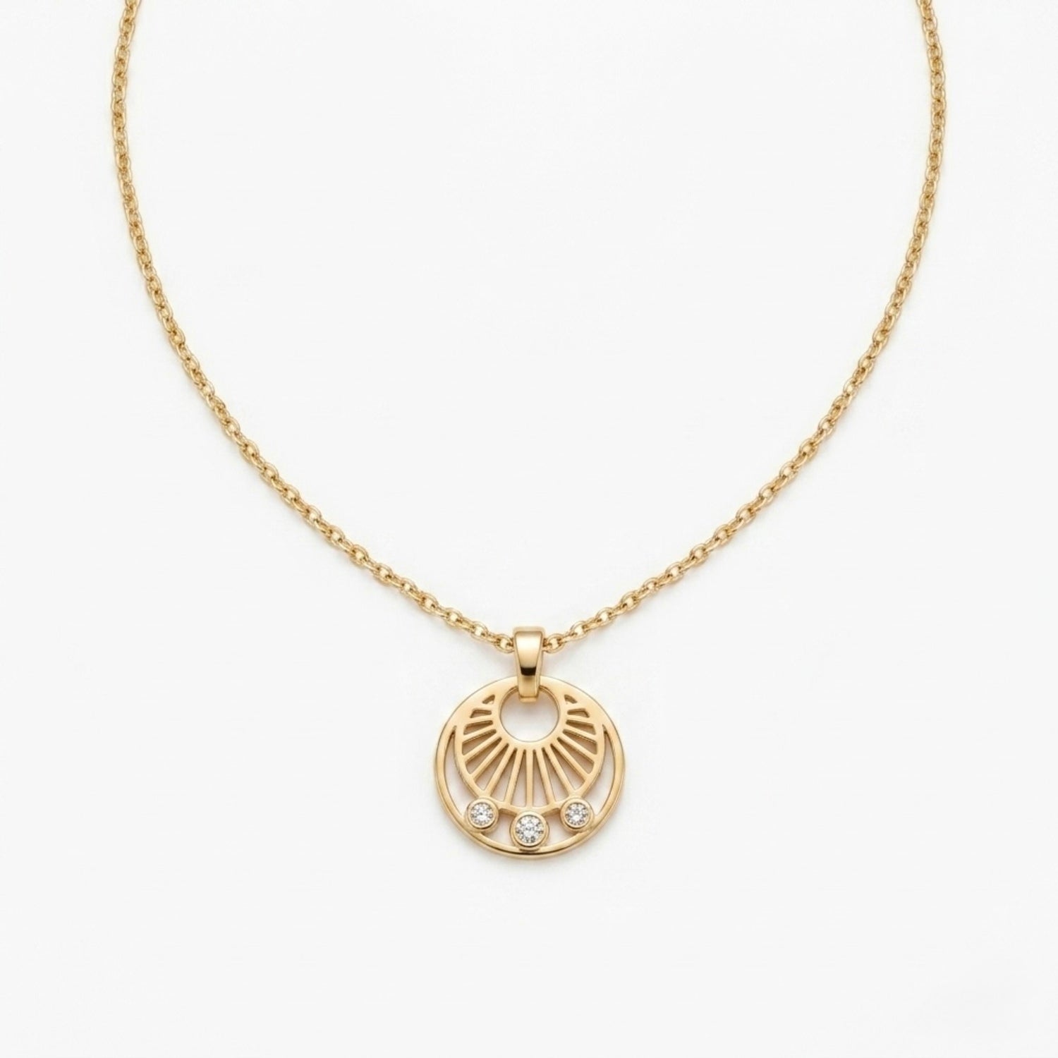 A gold-plated stainless steel necklace for women featuring a circular sunburst pendant with three small crystals at the bottom, shown against a white background
