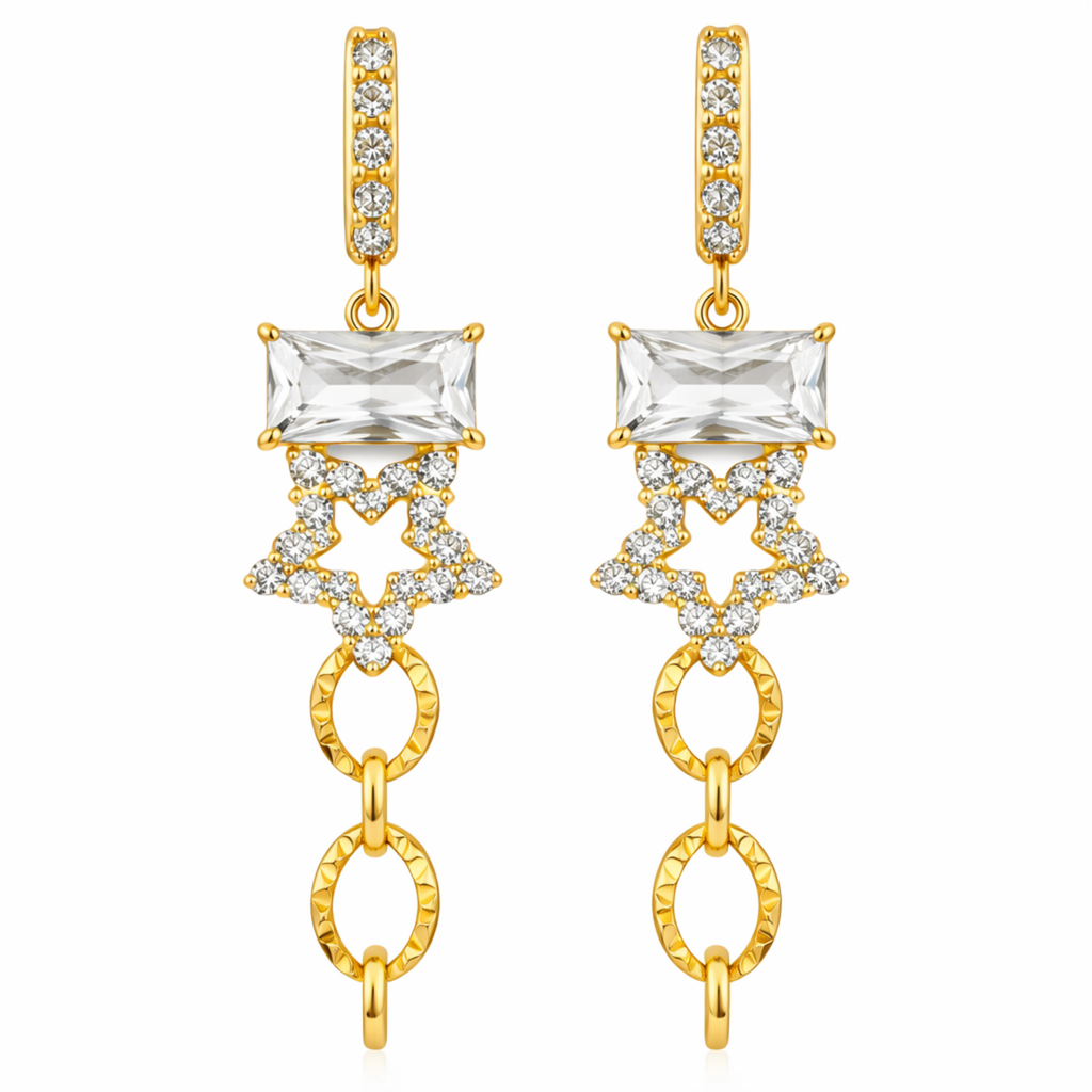 A pair of gold-plated long earrings for women featuring an emerald-cut crystal, a pavé star, and textured chain links, shown on a white background