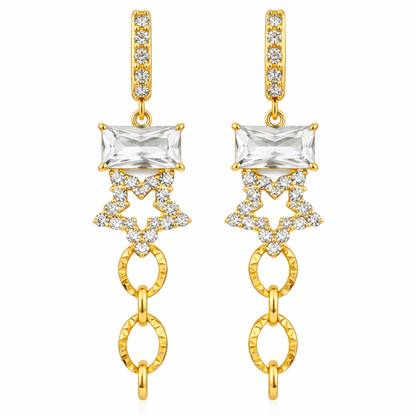 A pair of gold-plated long earrings for women featuring an emerald-cut crystal, a pavé star, and textured chain links, shown on a white background