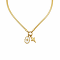 A close-view of a gold-plated stainless steel chain for women featuring a flat snake chain and two celestial star charms, one with a pearl inlay
