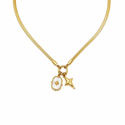 A close-view of a gold-plated stainless steel chain for women featuring a flat snake chain and two celestial star charms, one with a pearl inlay