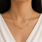 A gold-plated stainless steel chain for women featuring a curved drop of nine small crystal-set stars, shown on a model