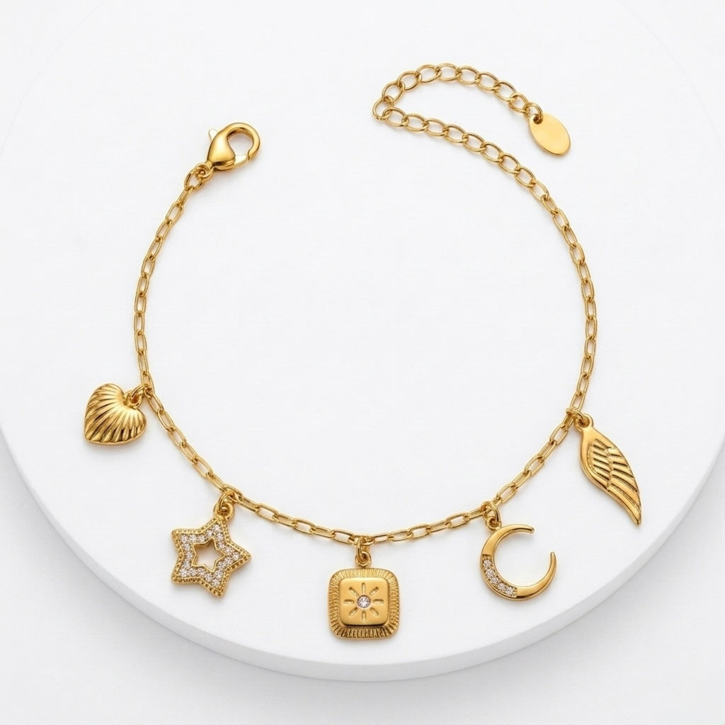 A gold-plated charm bracelet for women featuring five dangling celestial charms including a sun, star, moon, heart, and wing.