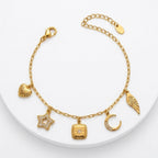 A gold-plated charm bracelet for women featuring five dangling celestial charms including a sun, star, moon, heart, and wing.