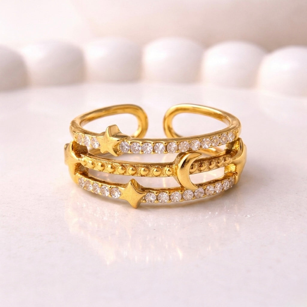 gold plated adjustable ring for women with a triple-band design featuring a crescent moon, stars, and rows of sparkling stones on a white surface