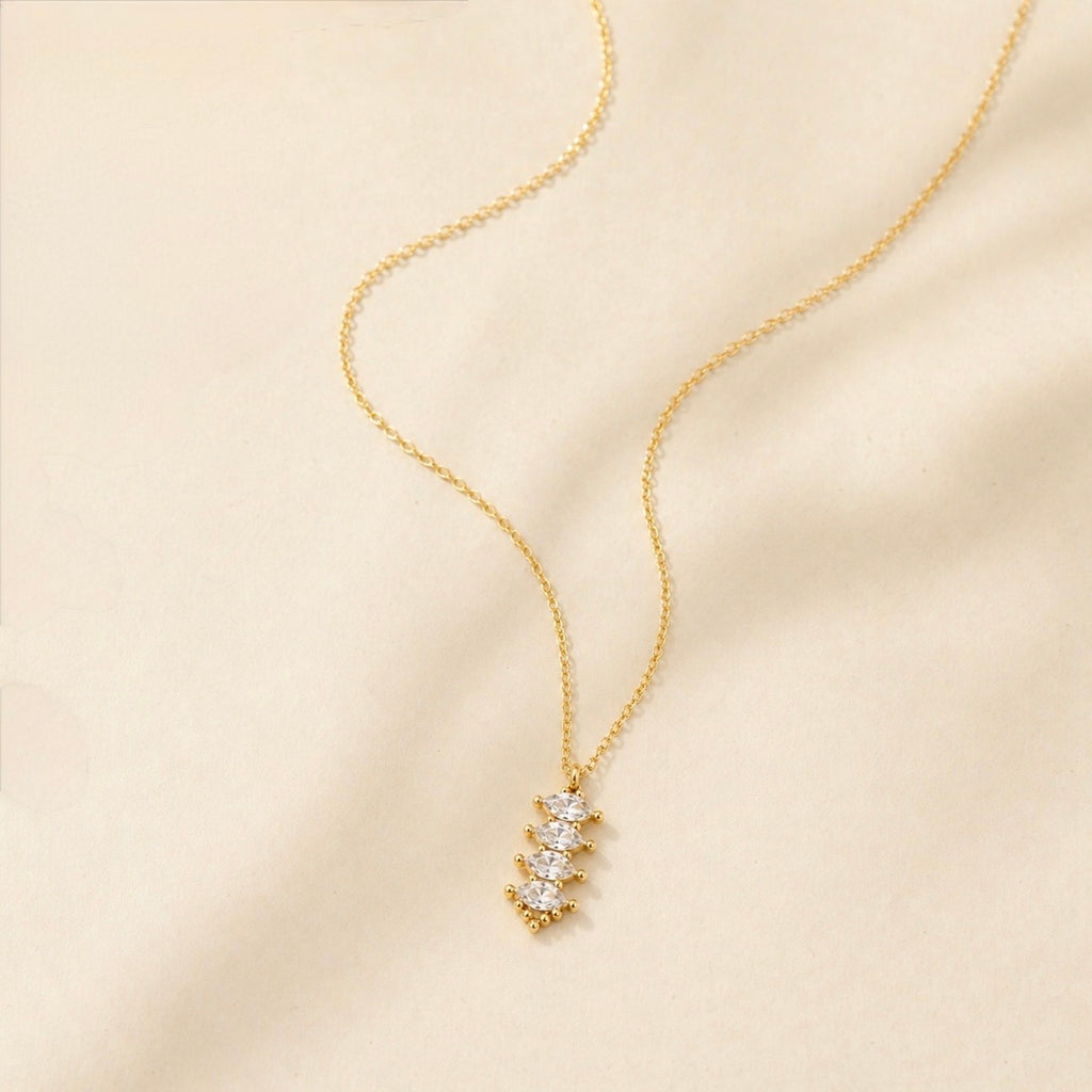 A gold-plated stainless steel chain for women featuring a vertical pendant with four stacked marquise-cut crystals