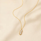 A gold-plated stainless steel chain for women featuring a vertical pendant with four stacked marquise-cut crystals