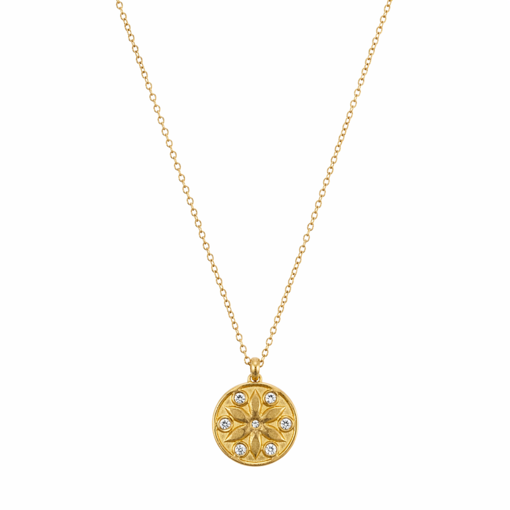 A gold-plated stainless steel chain for women featuring a circular medallion pendant with an embossed star pattern and seven sparkling crystals.