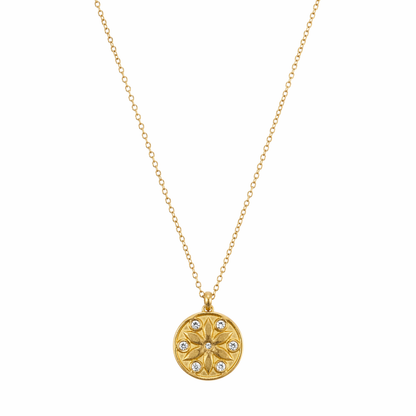 A gold-plated stainless steel chain for women featuring a circular medallion pendant with an embossed star pattern and seven sparkling crystals.
