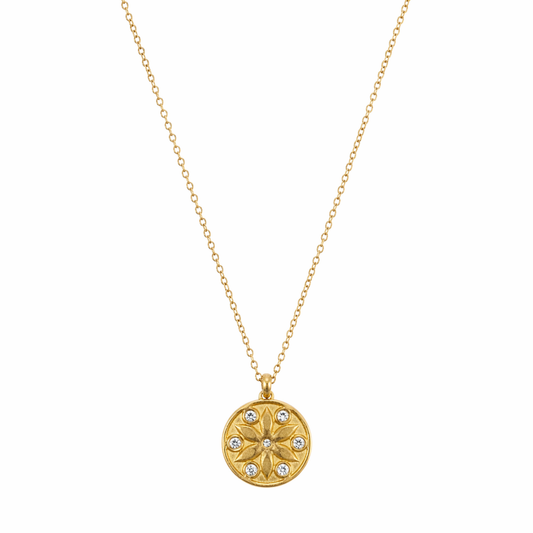 A gold-plated stainless steel chain for women featuring a circular medallion pendant with an embossed star pattern and seven sparkling crystals.