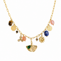 A close-view of a gold-plated stainless steel chain for women featuring paperclip links and a variety of charms including a ginkgo leaf, lapis lazuli, and rose quartz beads