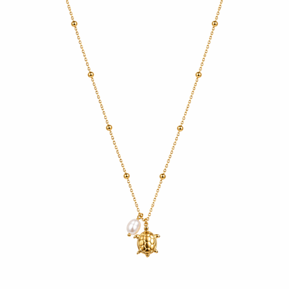 A gold-plated stainless steel chain for women featuring small bead stations and a sea turtle pendant with a single pearl