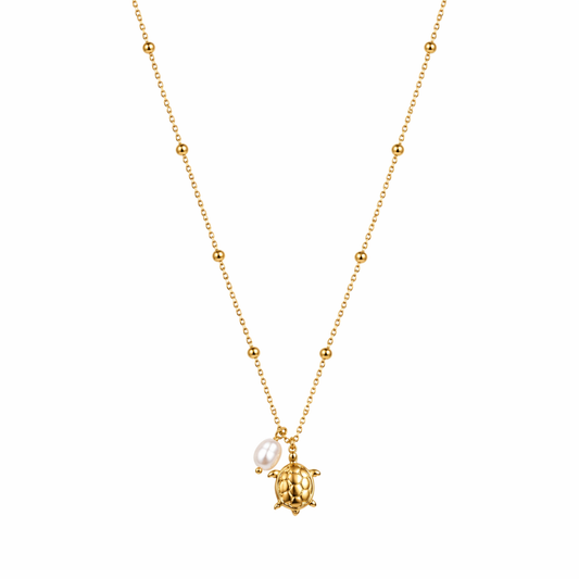 A gold-plated stainless steel chain for women featuring small bead stations and a sea turtle pendant with a single pearl