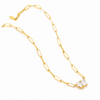 Gold chain necklace with a clear crystal pendant on a white background