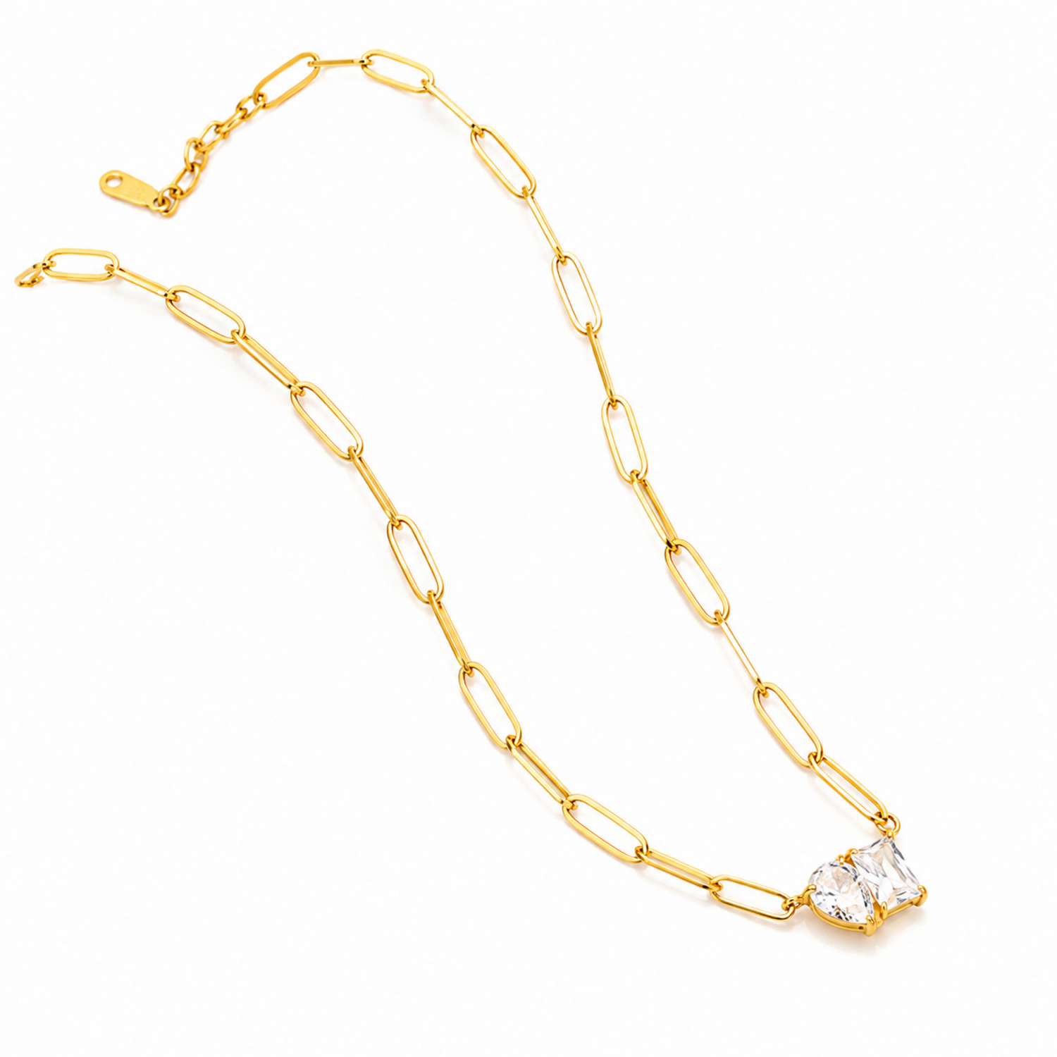 Gold chain necklace with a clear crystal pendant on a white background