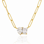 Gold chain necklace with two clear gemstones on a white background