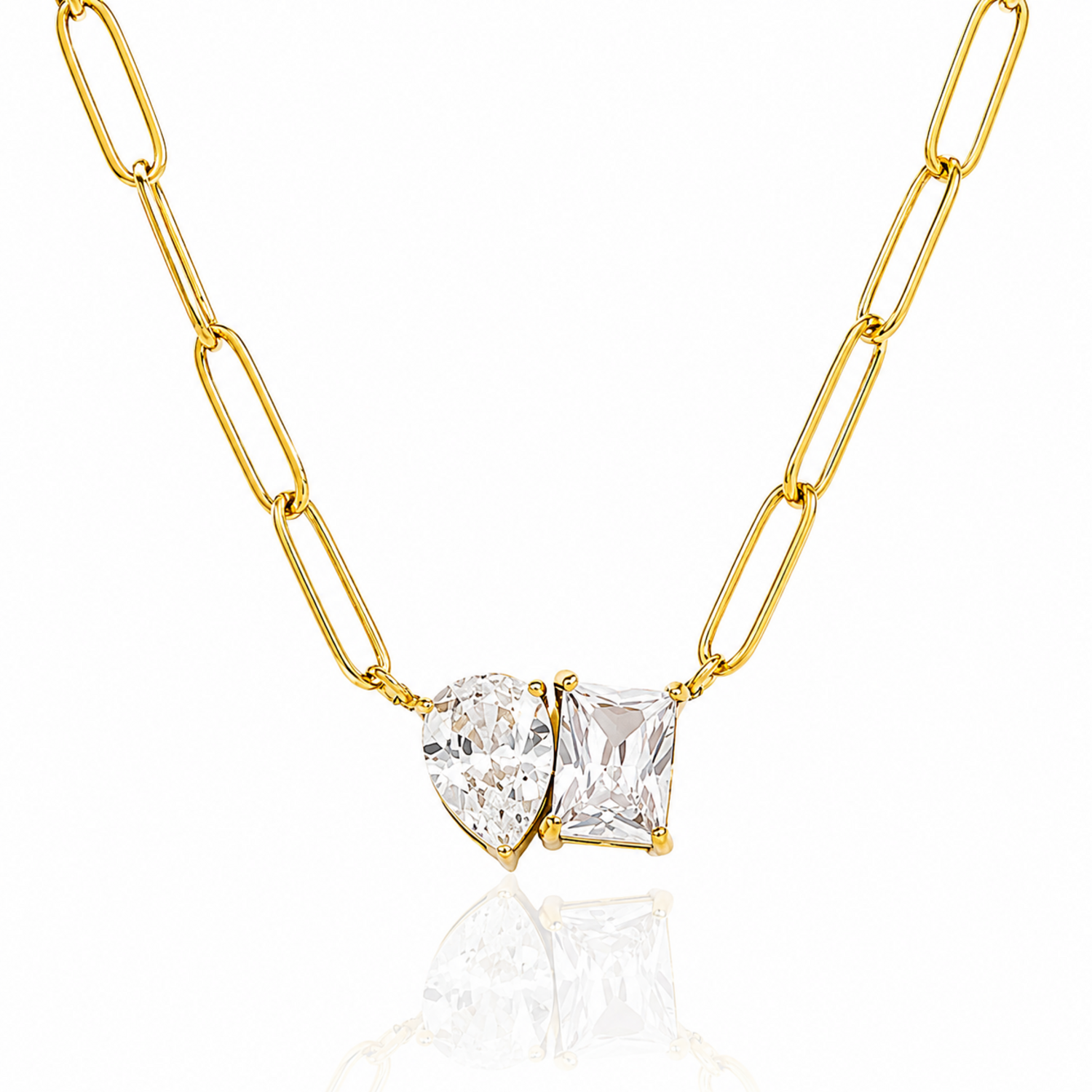 Gold chain necklace with two clear gemstones on a white background